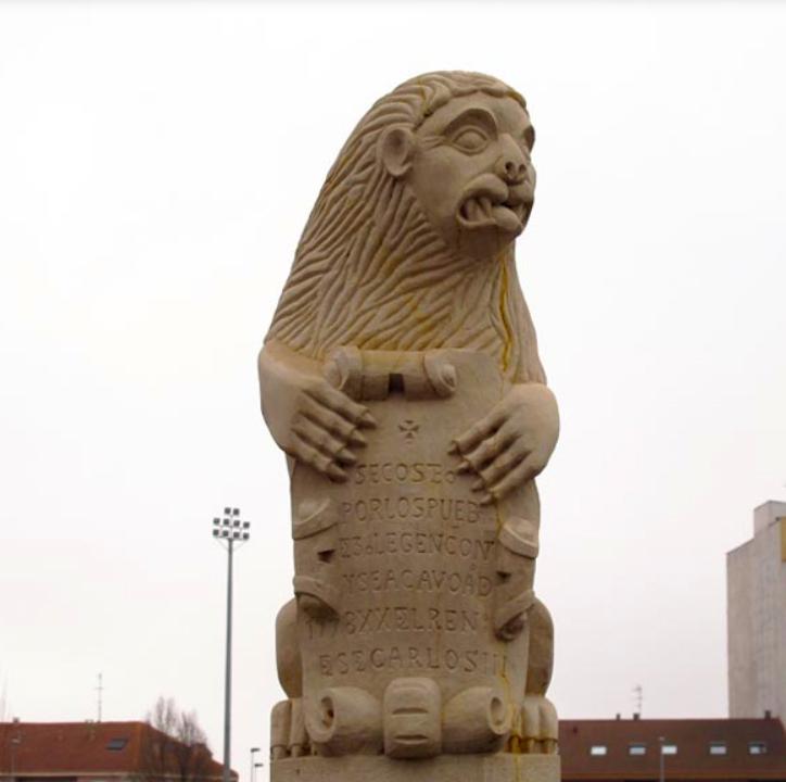 Esculturas de leones en posición sedente en el puente de Puente Castro en León.